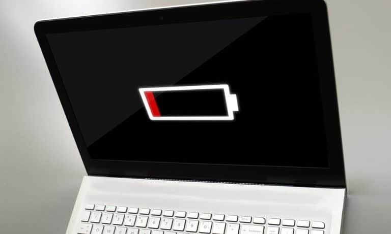 Laptop battery icon showing low battery warning with the percentage rapidly decreasing on Windows 11 desktop