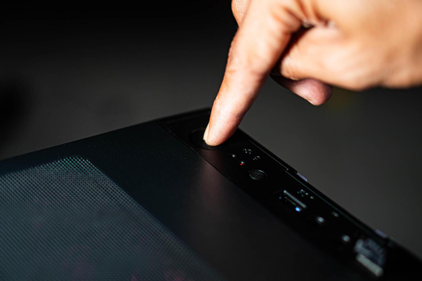 Fix laptop wont turn on no power Windows 11 showing hand pressing power button on unresponsive laptop